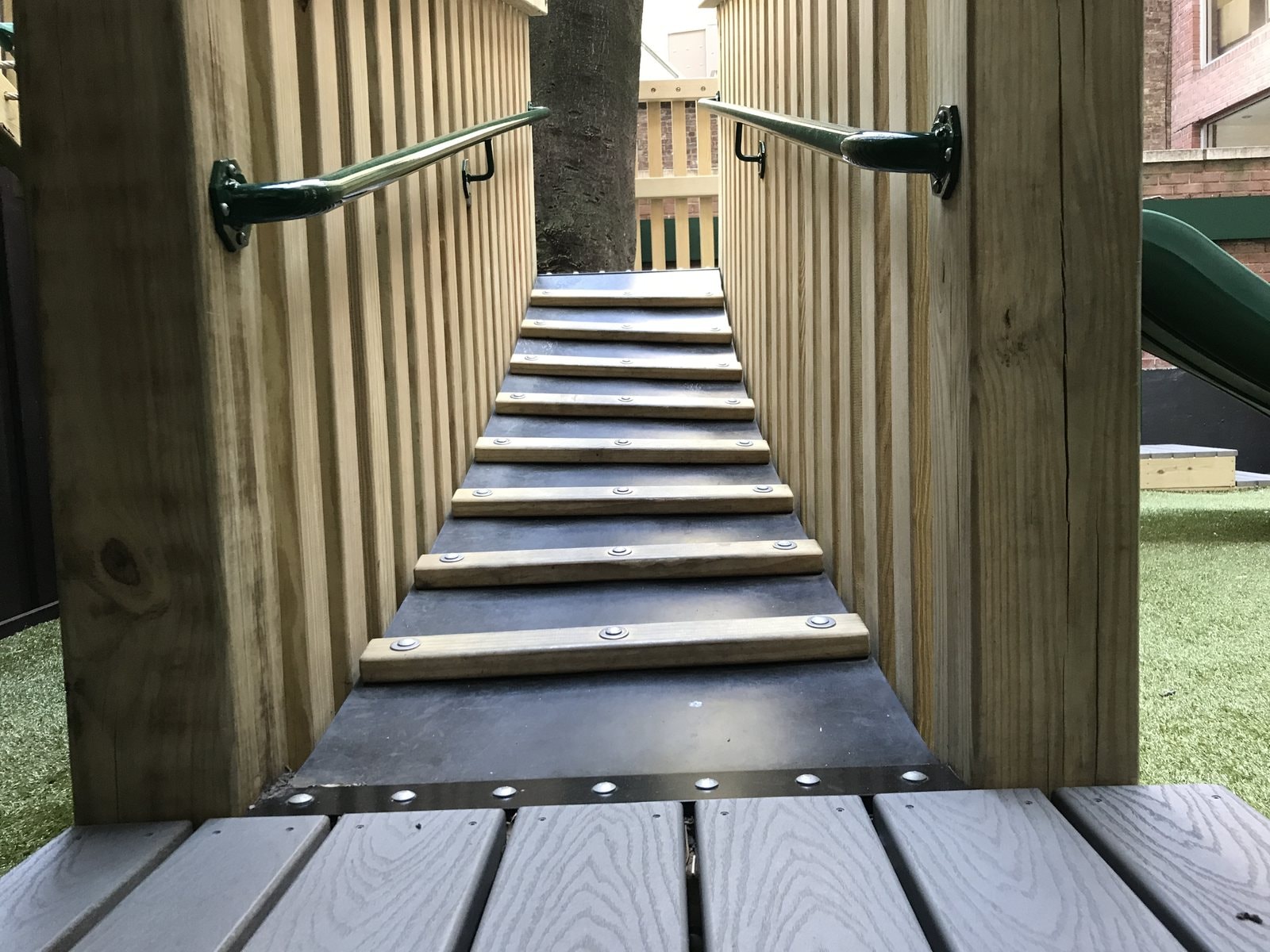 A ramped walkway combining composite decking and timber cleats.