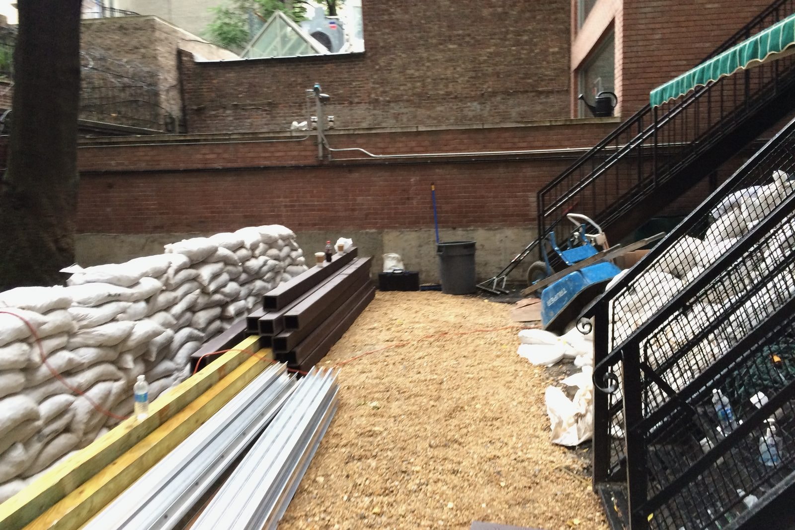 Site prep: cleared ground with new lumber and materials delivered.