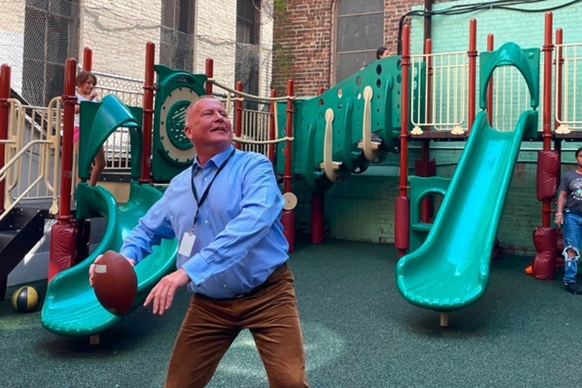 Ground-level shot of the old teal and red playground structure.
