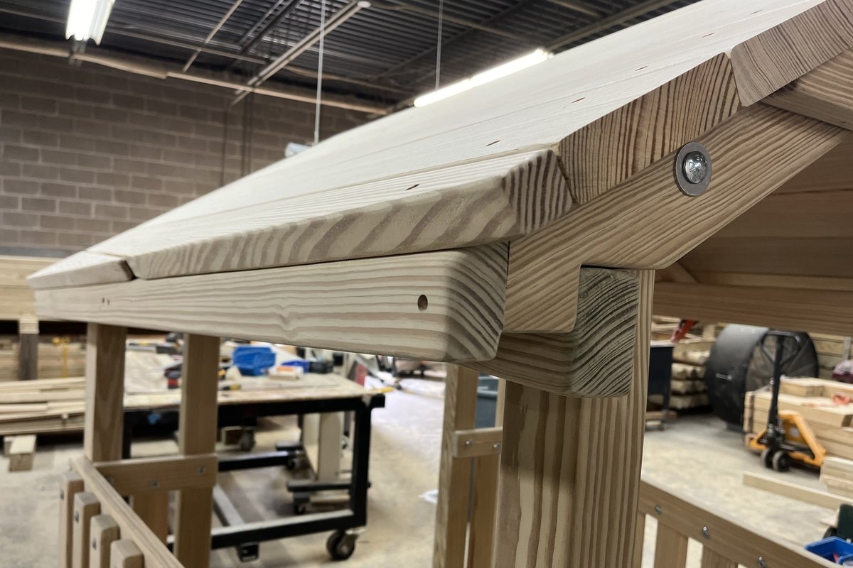 Close-up of a prefabricated wood roof eave and fascia detail in the shop.