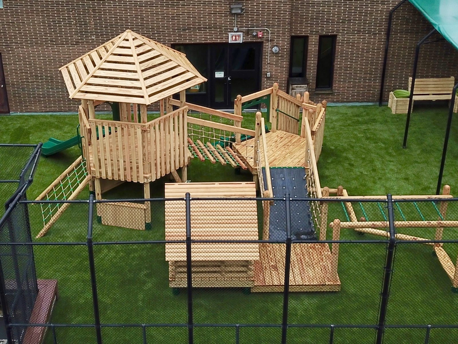 Aerial view looking west across the rooftop play area and tower.