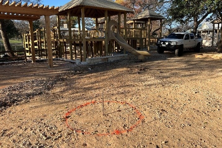 Before: cleared site with the layout marked out on the ground