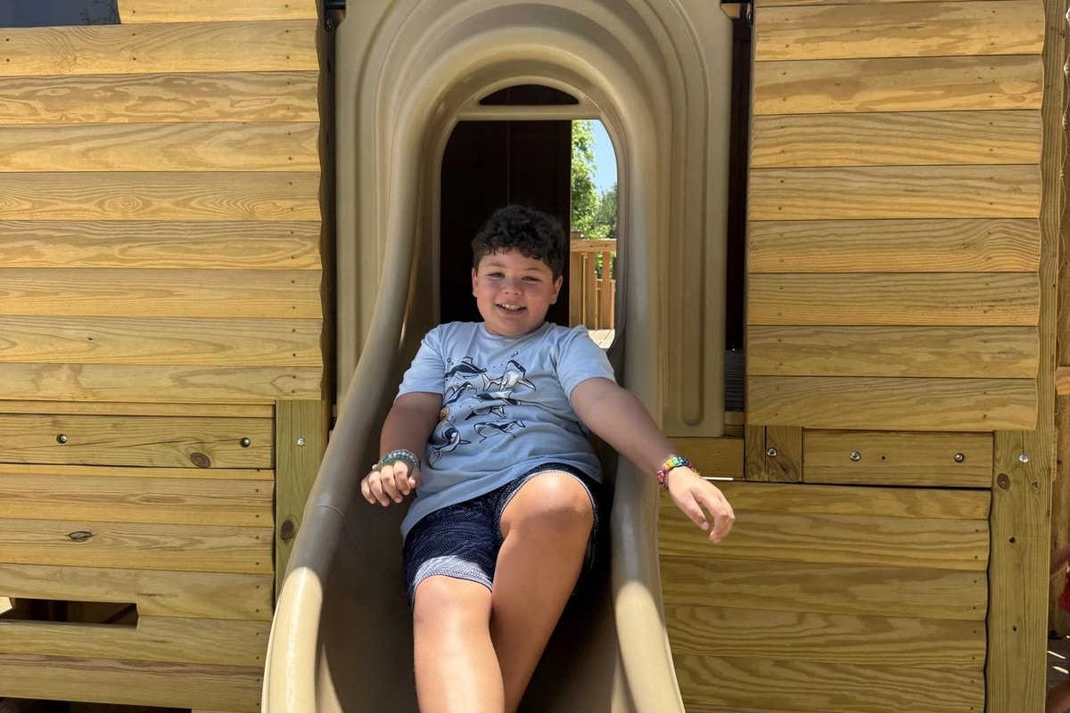 A boy sliding out of a fort house