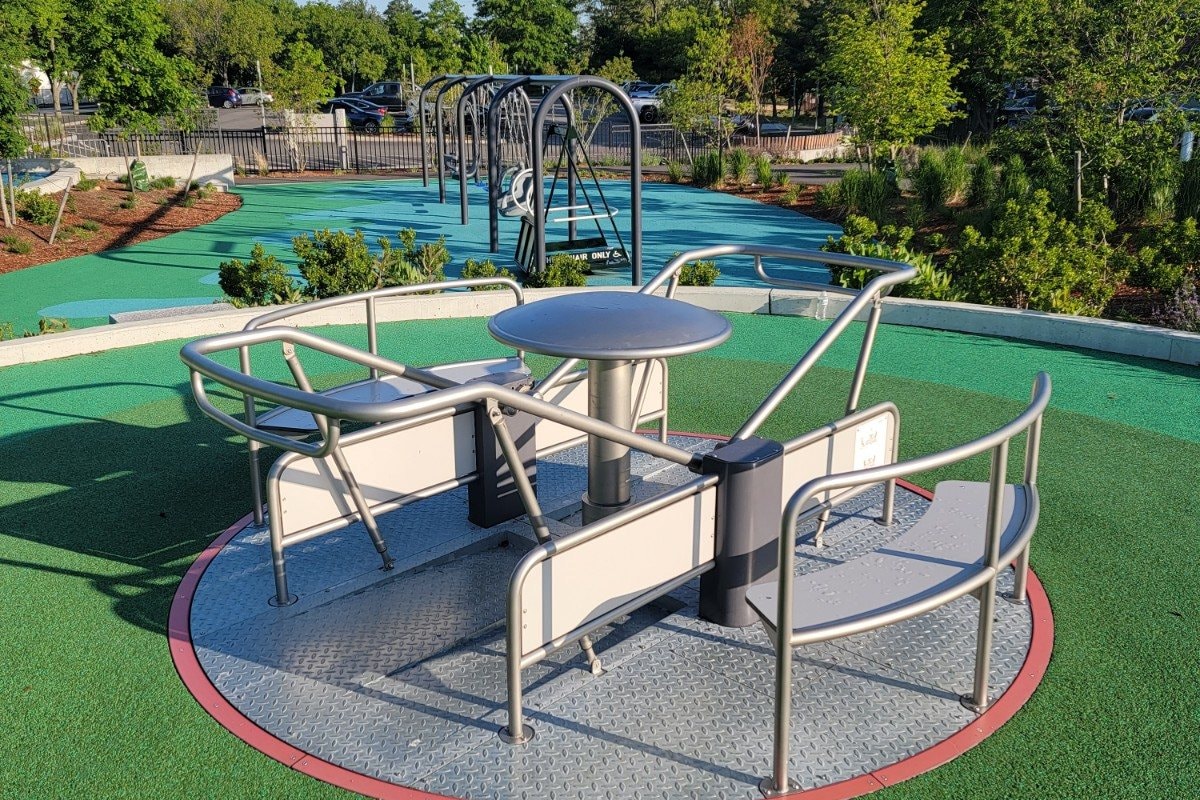 An accessible spinner set into poured-in-place safety surfacing.
